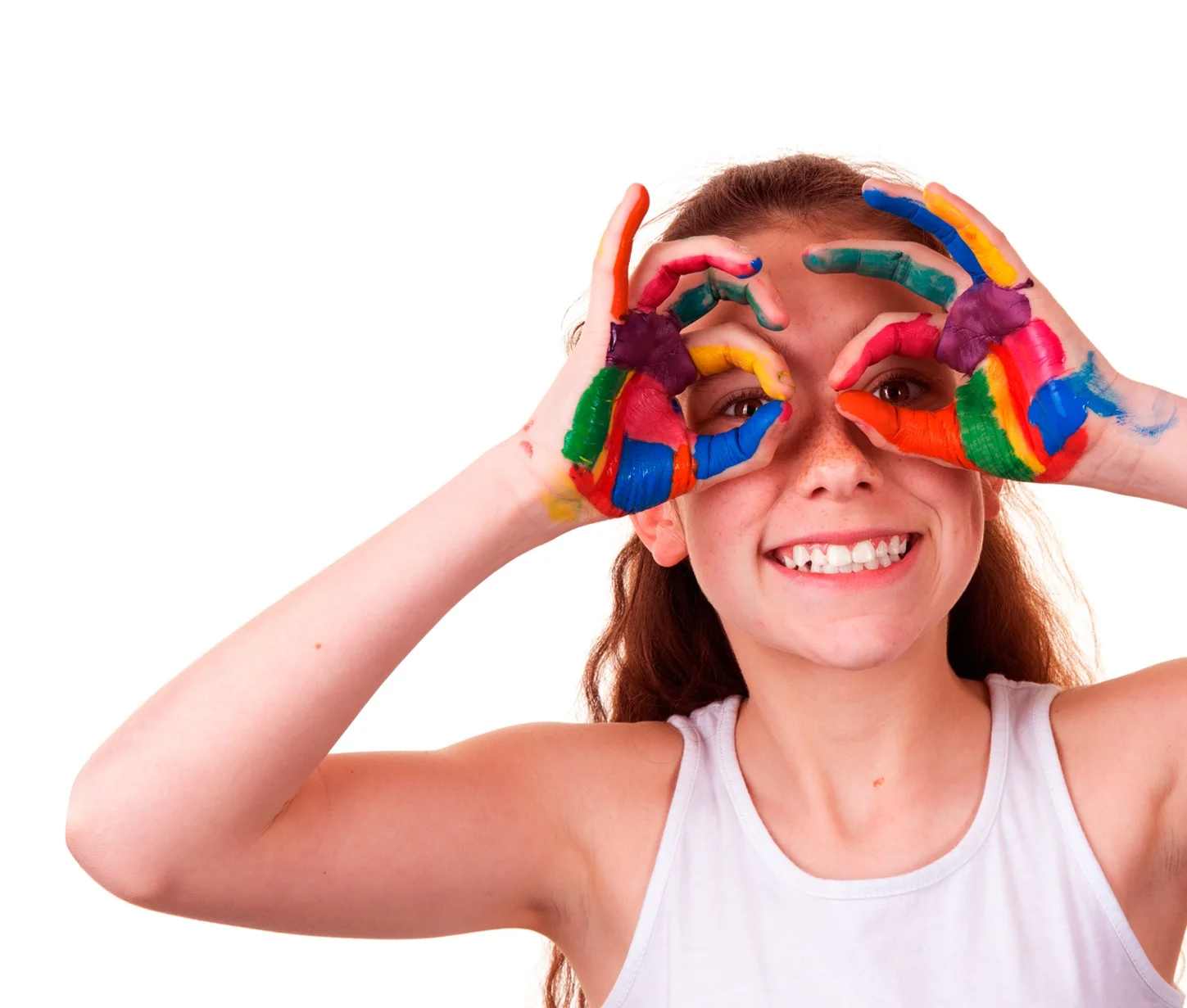 Girl with colorful paint on hands making circles around eyes, smiling.