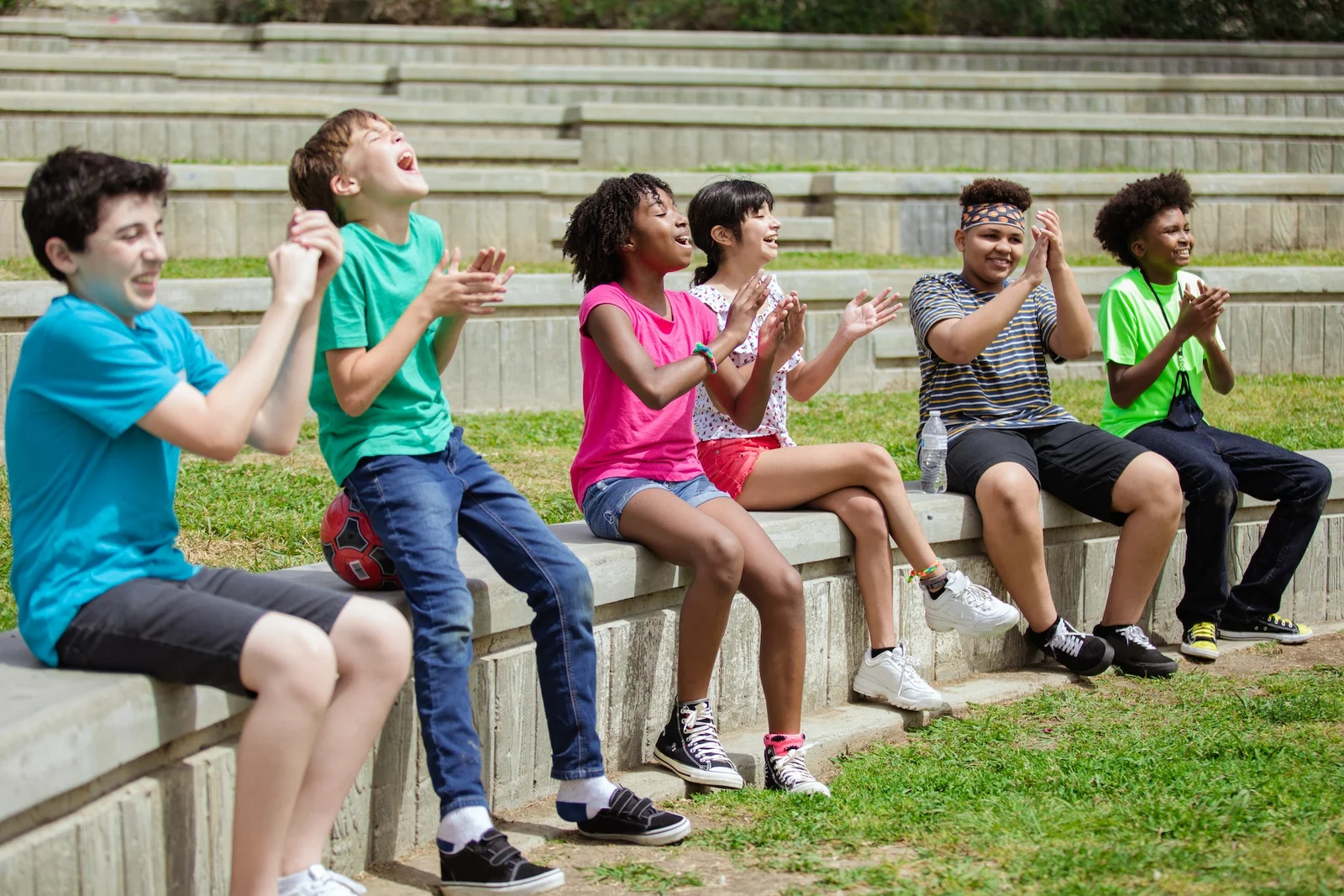 Children clapping and cheering outdoors.