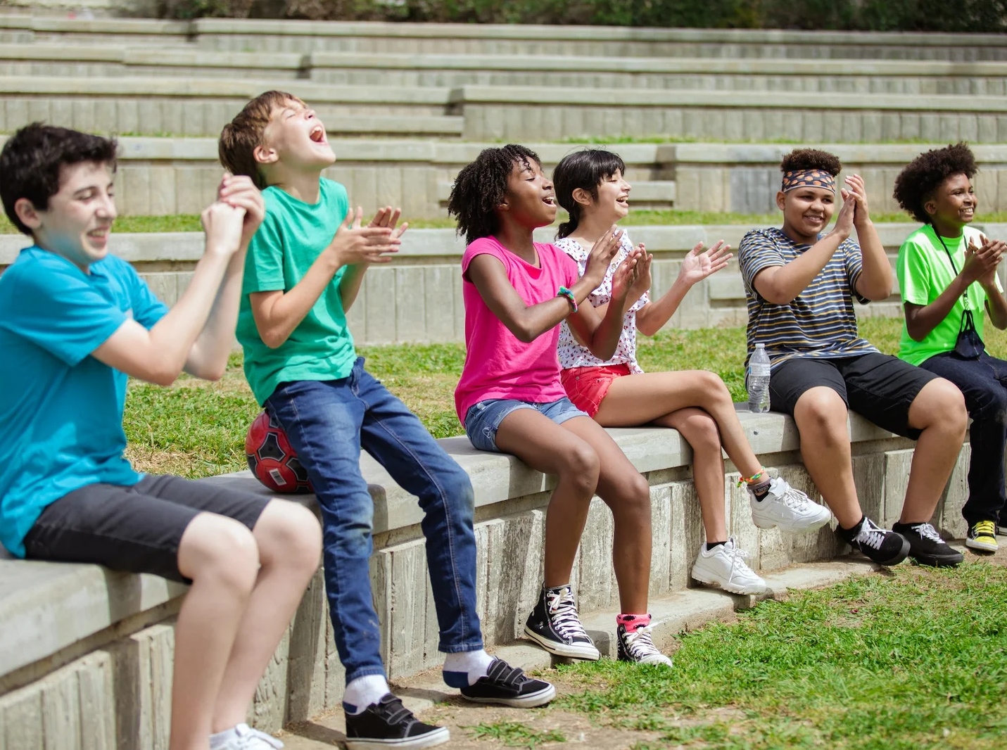 Children clapping and cheering outdoors.
