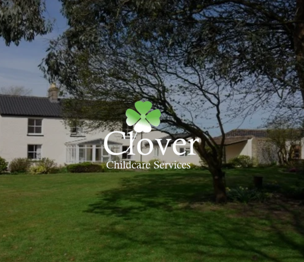 A logo with a clover and "Clover Childcare Services" text is superimposed on a white building with a green lawn and trees in the foreground.